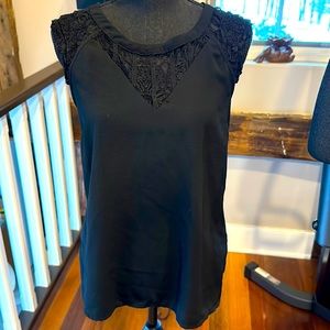 Sleeveless Top , lace on top solid black on the rest . Partial Zipper in back